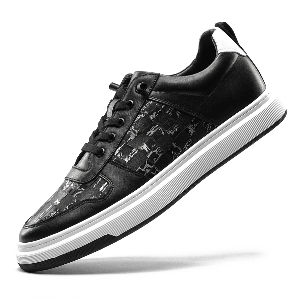 Dom Nocturne low-top sneaker in black leather with a monogram-patterned toe panel and a thick black-and-white striped sole